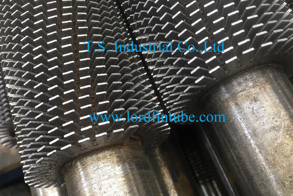 Helically wound serrated and continuously welded finned tubes